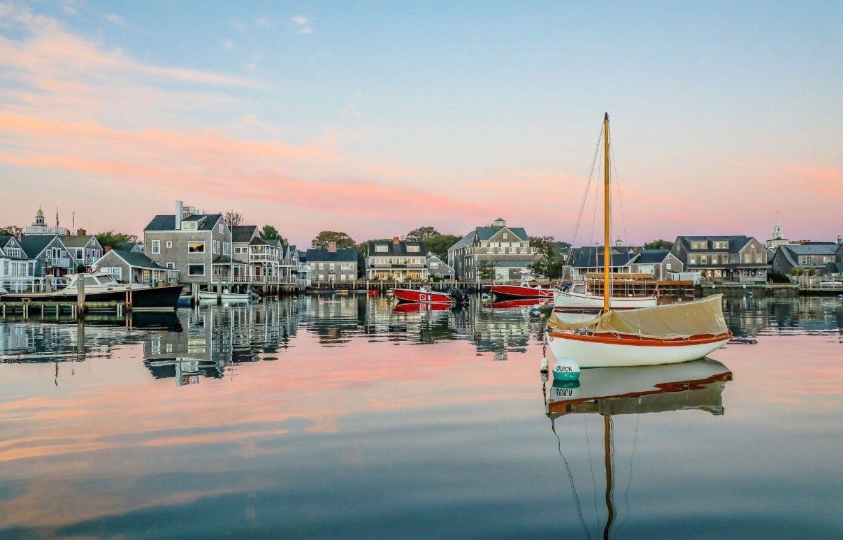 Boats moored in the harbour at sunset, the town behind.