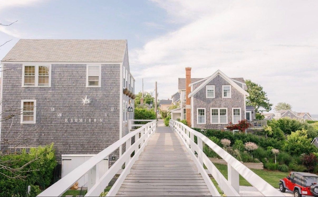 The white wooden footbridge at ’Sconset, grey-shingled houses beyond.