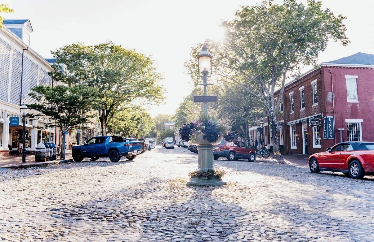 The cobblestones of Main Street, a gas lamp and flower urn at the centre.